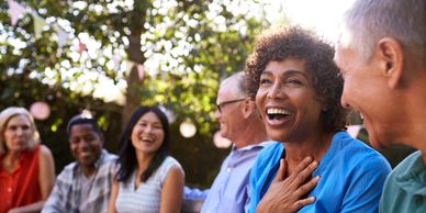 Group of diverse people laughing and enjoying outdoors.