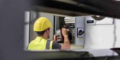 Electrician working on an electrical panel.