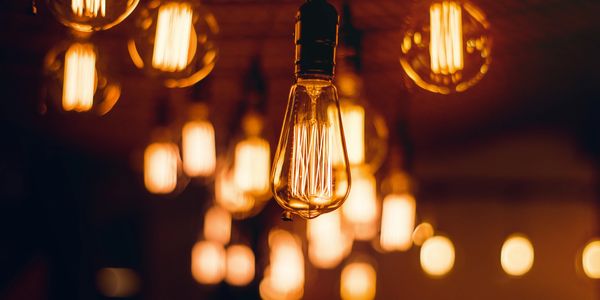 Close-up of vintage Edison light bulbs glowing warmly in a dim setting.