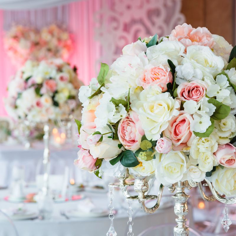 Wedding decorations bouquets of roses and eustoma in restaurant interior.