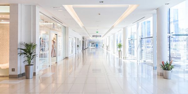 Interior hallway of a commercial shopping center showcasing lighting
