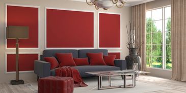 Modern living room with red accents and large window view.