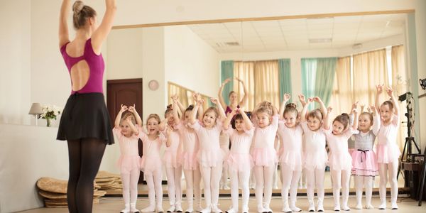 Young girls in ballet class imitating their instructor.
