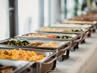 Buffet table with various hot dishes.