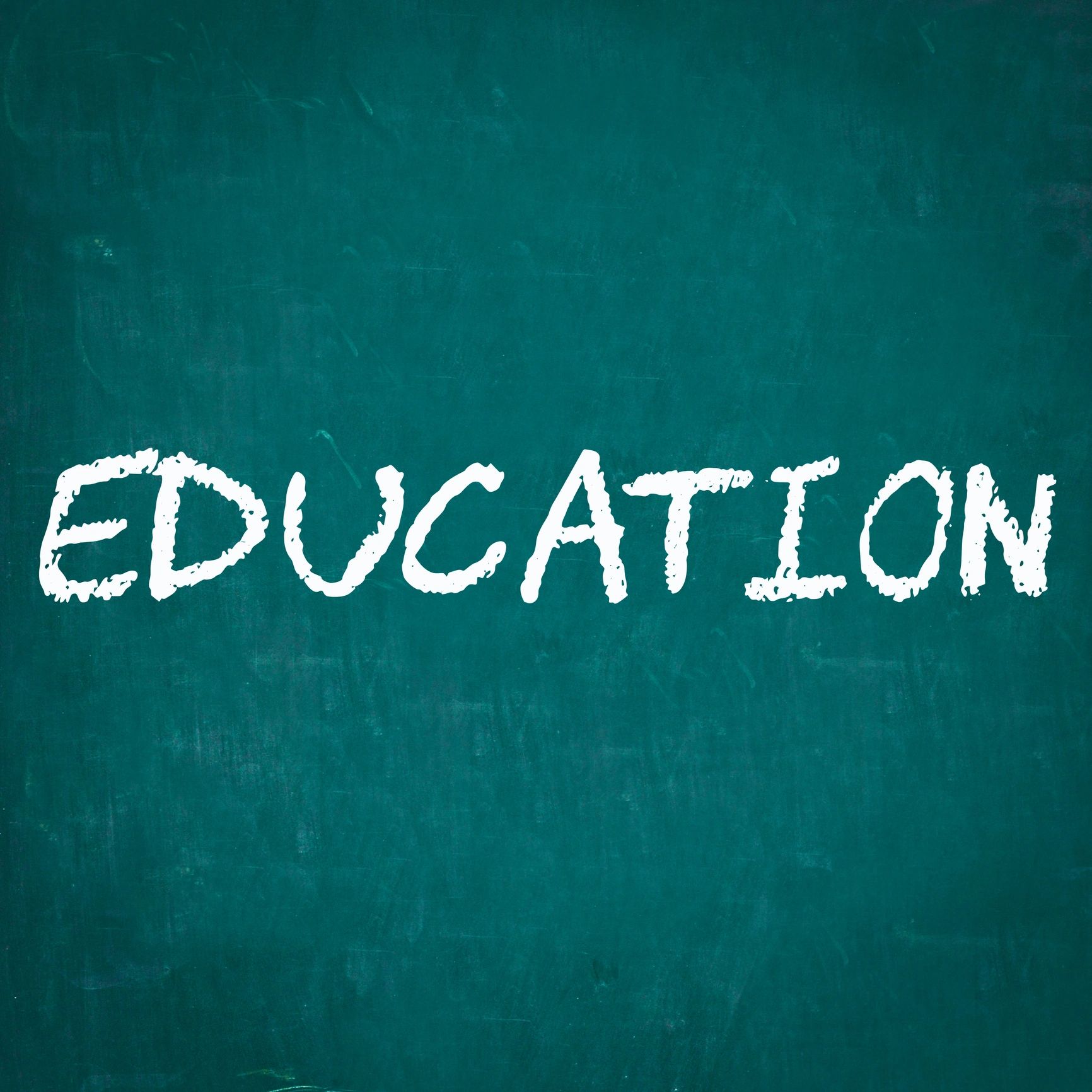 Word 'EDUCATION' written on a green chalkboard.