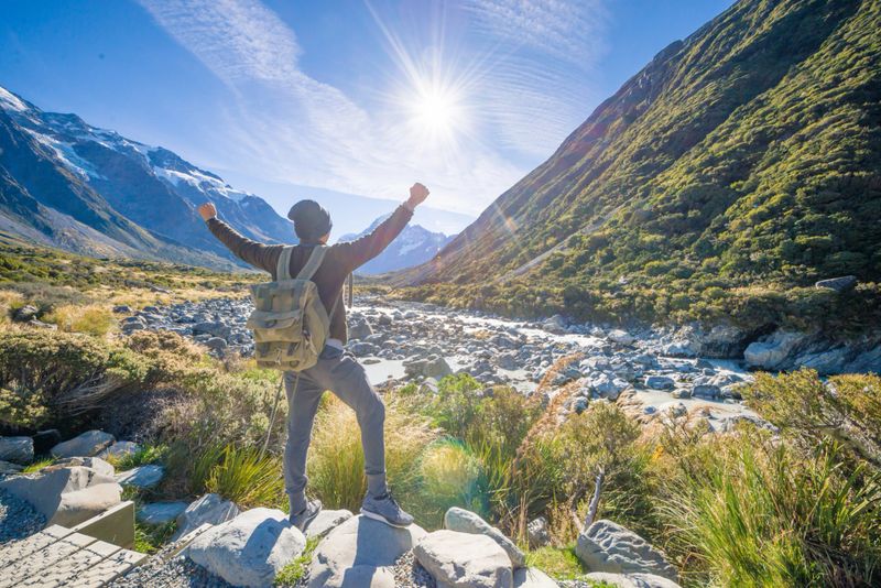 Young travler taking photo at mt cook mountain popular place new zealand