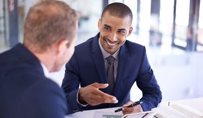 Two men engaged in a business meeting.