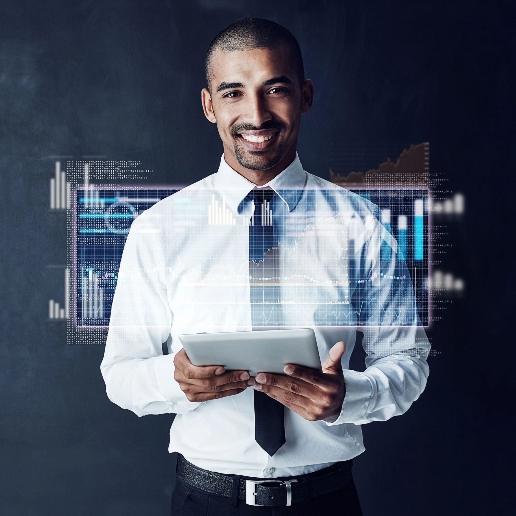 Smiling businessman using tablet with digital financial charts overlay.