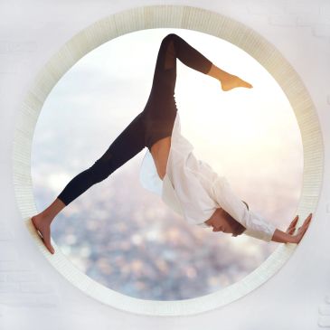Person performing a yoga pose in a circular window frame.