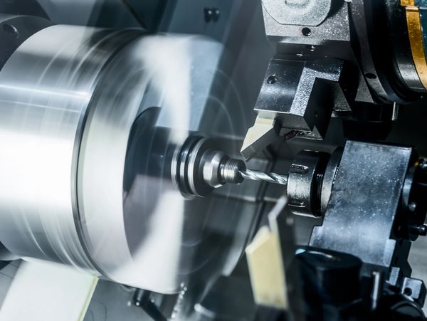 Drilling operation on a CNC lathe. Drill is creating a hole in the center of a hydraulic rod.