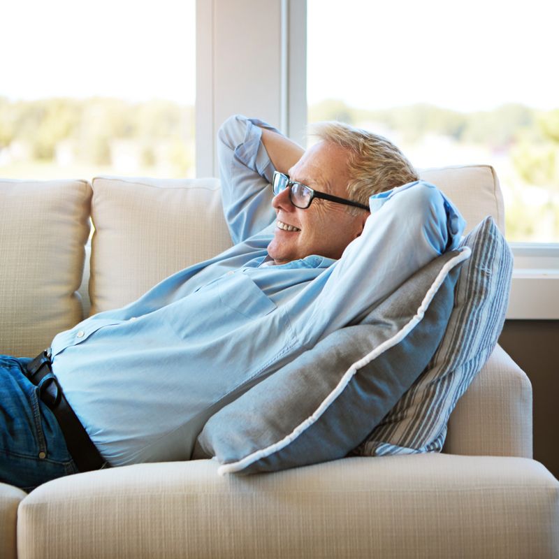 Shot of a happy mature man relaxing on the sofa at home