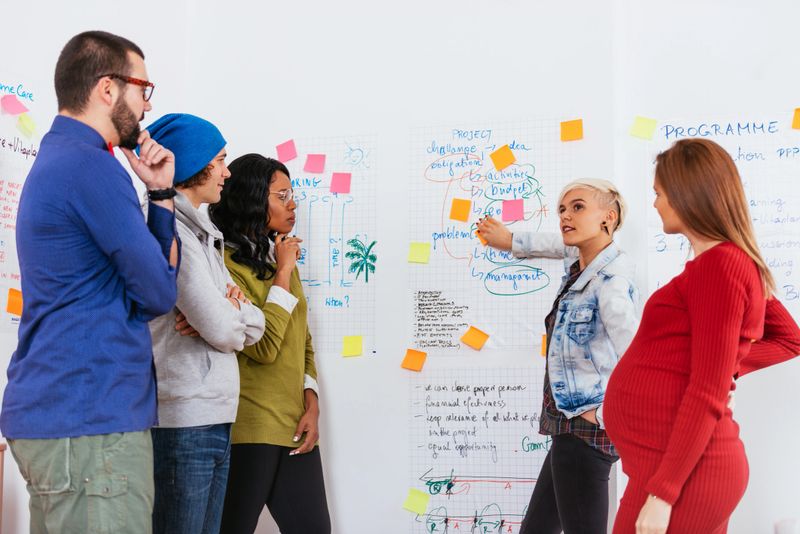 Diverse group of professionals collaborating on startup projects in a modern office