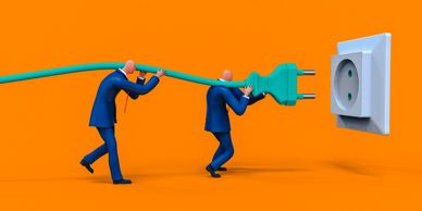 Two men carrying a giant electrical plug towards an outlet.