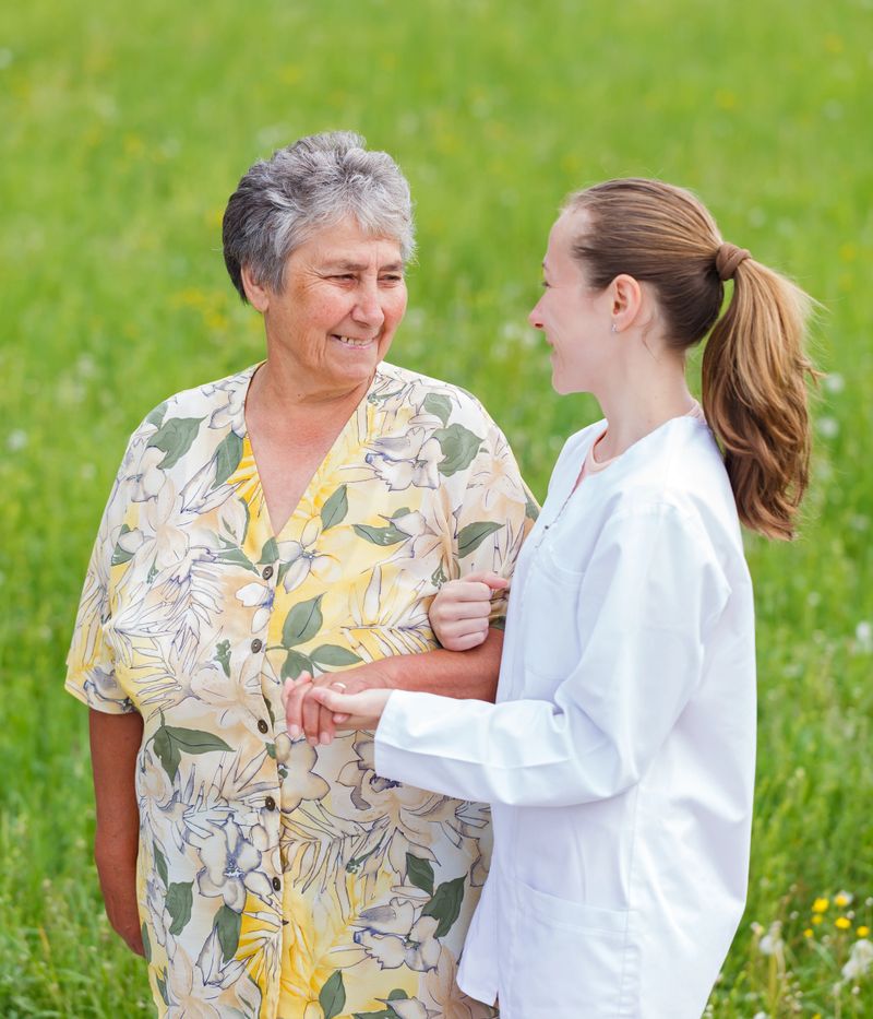 Elderly woman with her caretaker walking in the nature