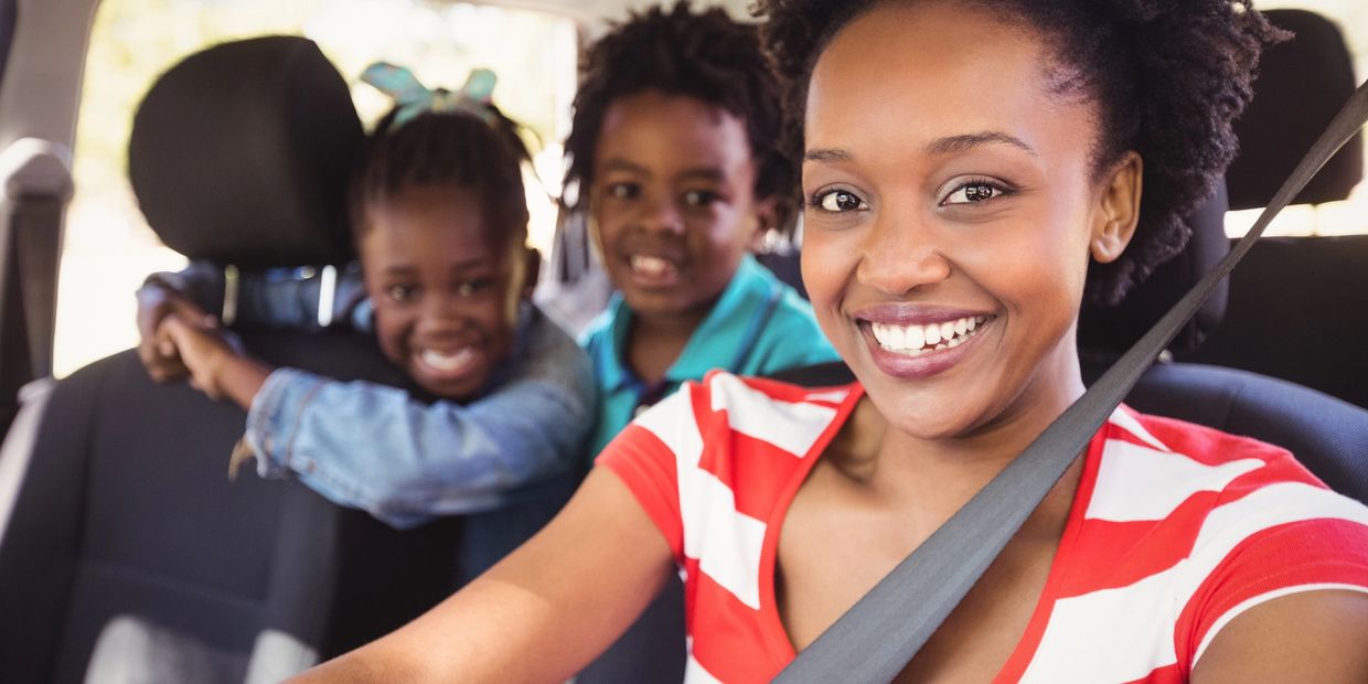A woman drving children to school. EverTrust Transit is looking for such drivers in Philadelphia