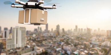 Drone delivering a package over a city.