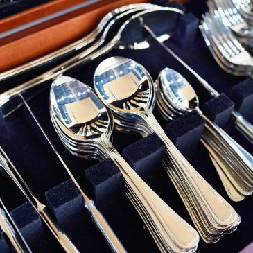 Set of shiny silver spoons in a box.