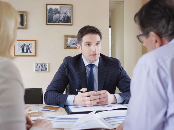 Happy couple reviewing estate documents at home.