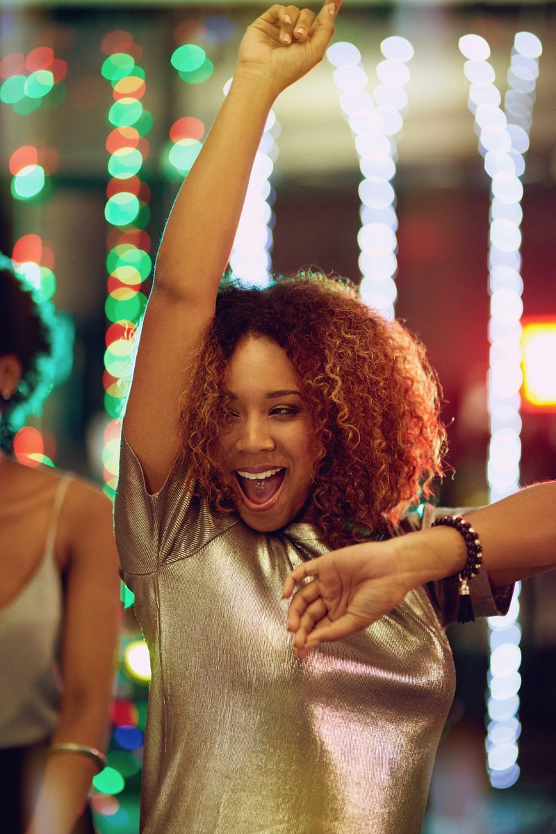 Shot of a young woman having fun on the dance floor
