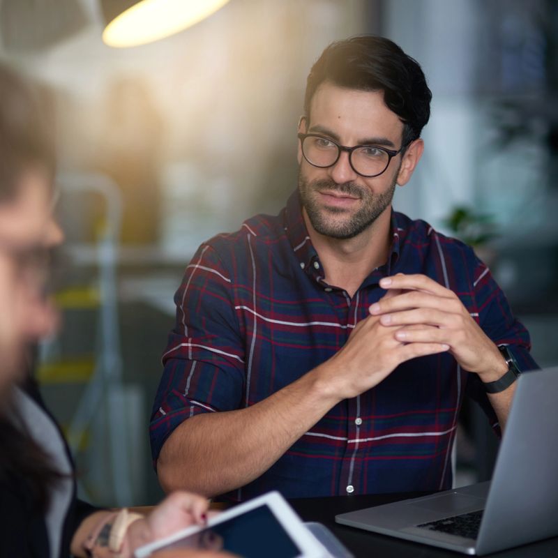 Shot of an unimpressed businessman listening to his colleague's ideas in the boardroom