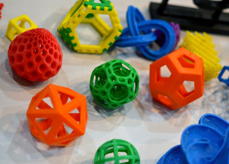 Objects printed by 3d printer. Bright colorful objects printed on a 3d printer on a table