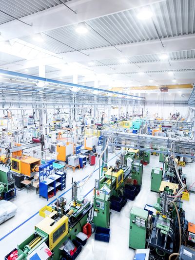 Bright, organized industrial manufacturing facility with machinery.