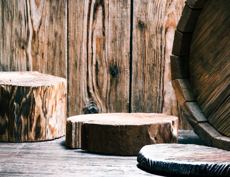 Beer theme with raw wood pub counter. Natural stumps, serving boards and fragment of oak barrel