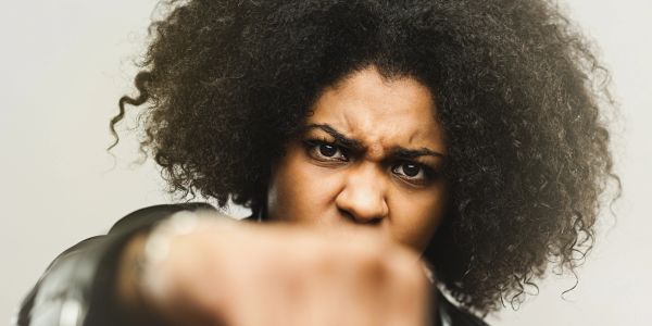 Angry woman with fist forward.