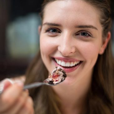 Woman enjoying dessert and smiling