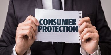 Person in suit holding paper with 'Consumer Protection' text.