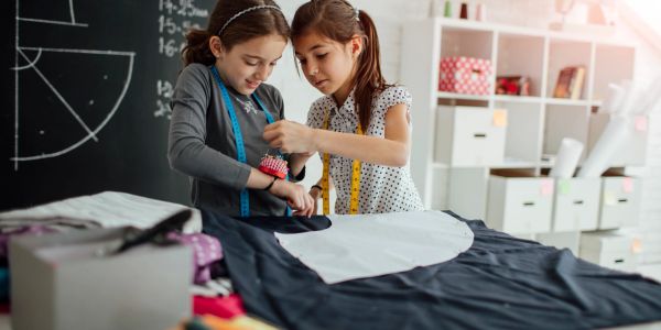Two girls at School of Couture are creating their first dress
