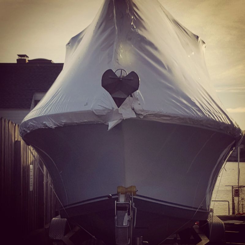 Boat shrink wrapped, with anchor showing