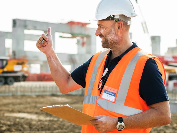 Construction worker giving a thumbs up on site.