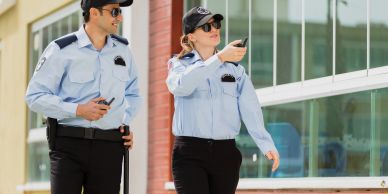 Two security guards communicating with walkie-talkies.