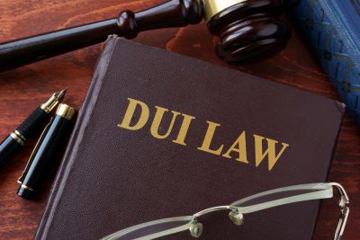DUI law book with gavel and glasses.