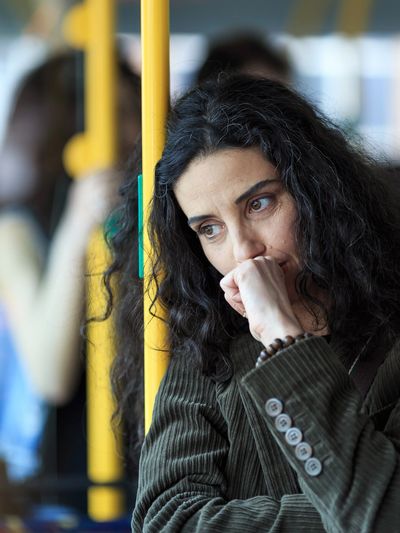 A woman riding the bus.