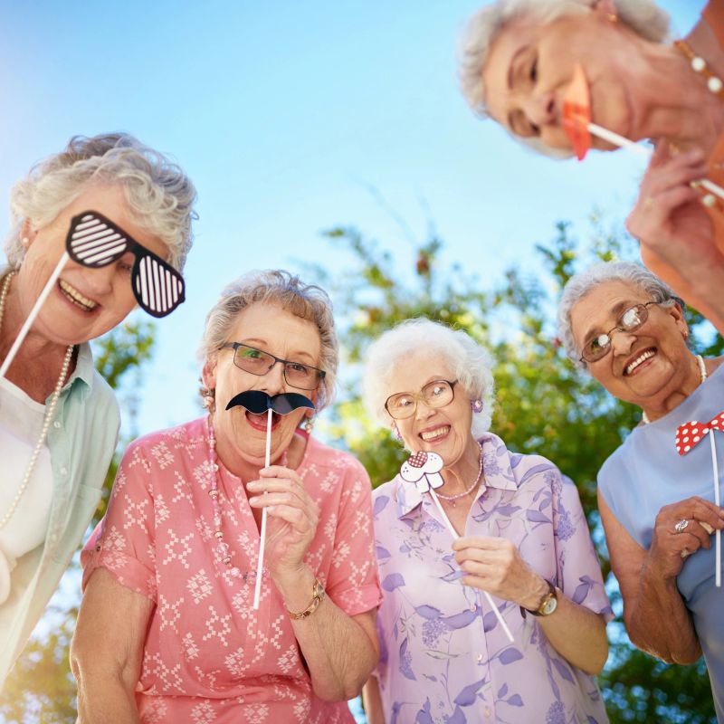 Cropped portrait of a group of quirky senior friends messing around outdoors