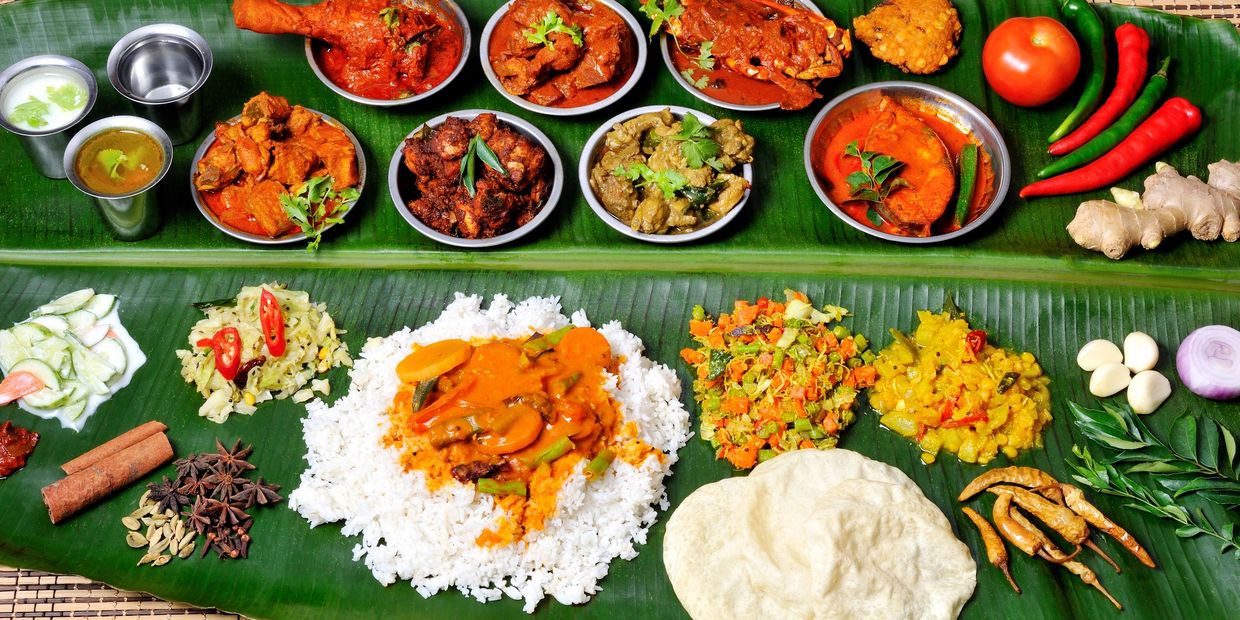 Traditional South Indian meal served on a banana leaf with rice, curries, and spices.