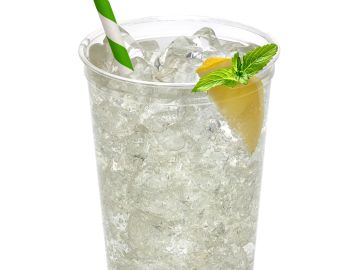 Clear iced drink in a plastic cup with lemon and mint.