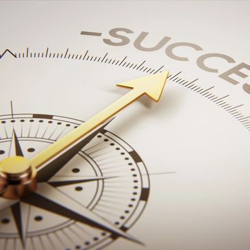Golden compass needle pointing towards the word 'SUCCESS'.