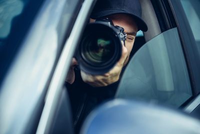 Private investigator using surveillance camera to capture evidence discreetly