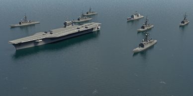 A naval fleet with an aircraft carrier and escort ships on calm water.