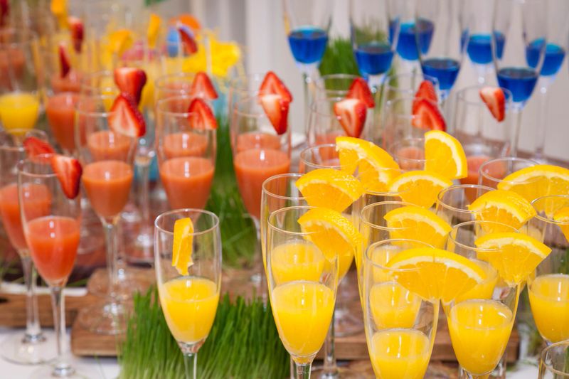 Colorful cocktails in champagne glasses on a table.
