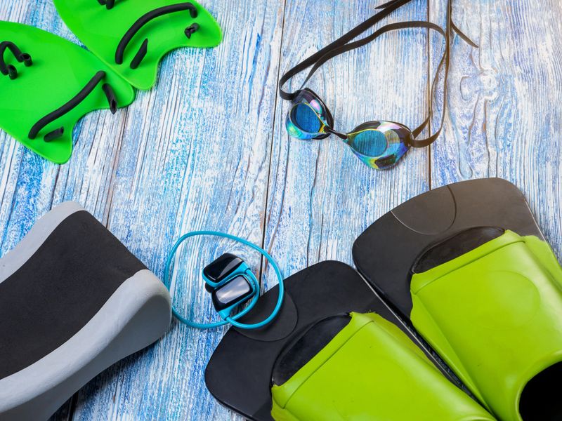 Accessories for sports swimming on wooden background sunshine