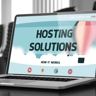 Laptop screen displaying a hosting solutions webpage with hot air balloons.