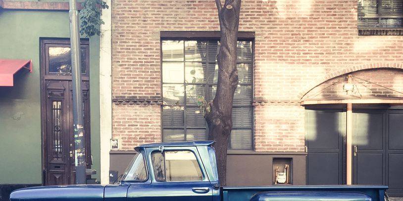 side image of a 1963 chevrolet C10 parked in front of a building