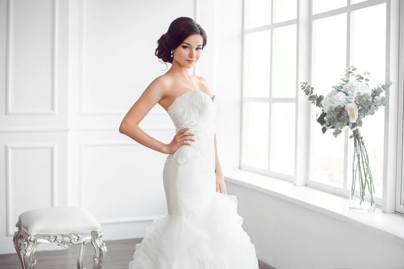 Elegant bridal gown displayed in a bright showroom at Bridal Dress For Less.