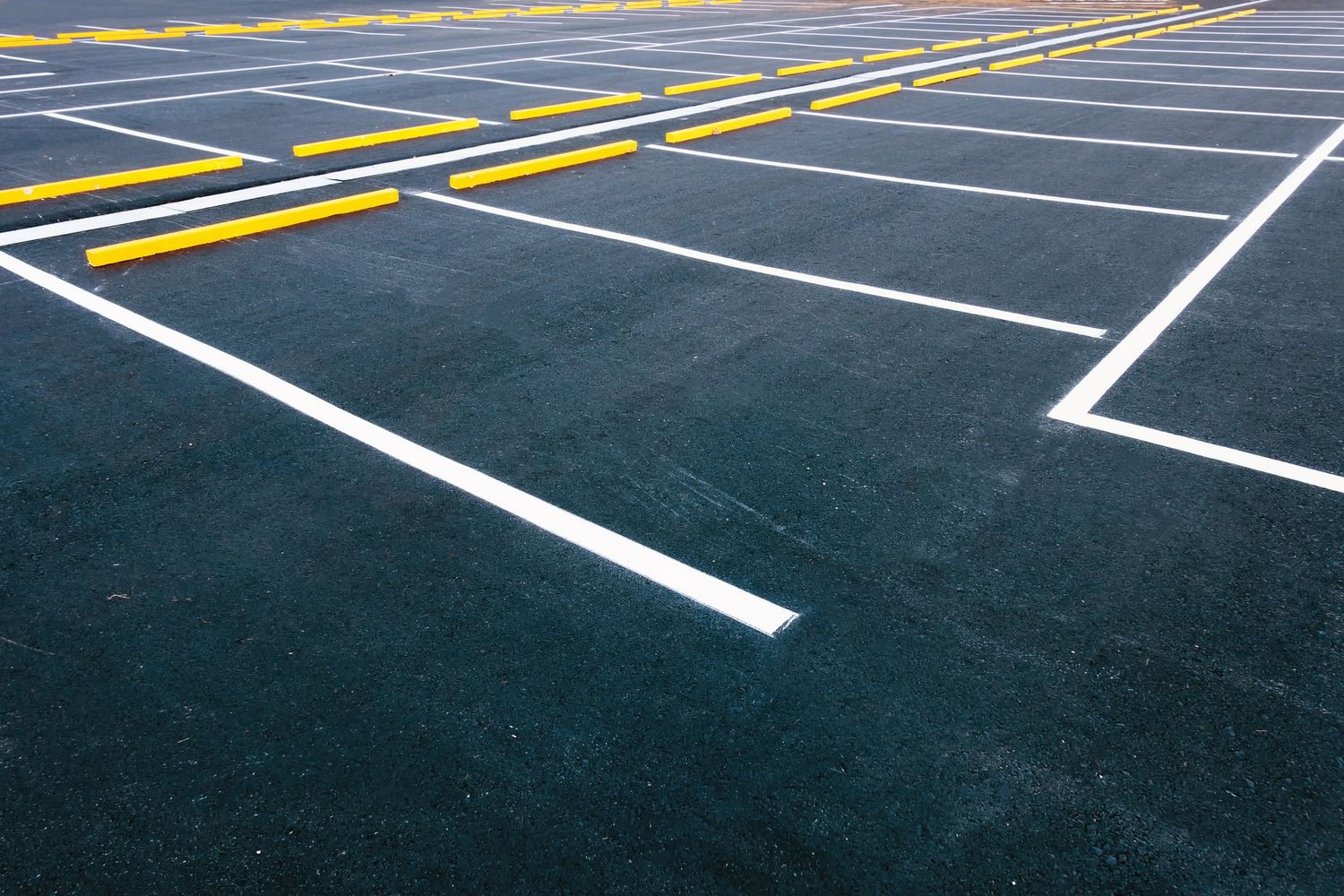 Empty parking lot with fresh white and yellow markings.