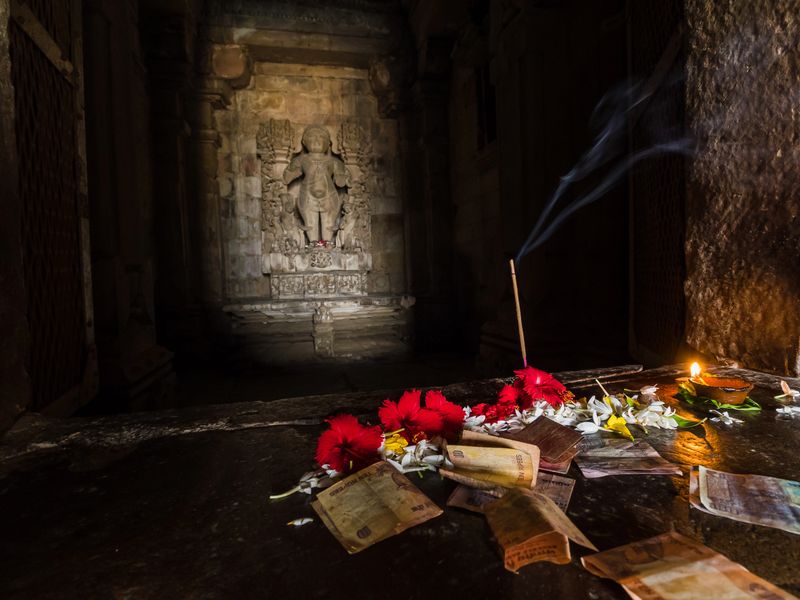 Selective focus shot of devotions in a hindu temple in India