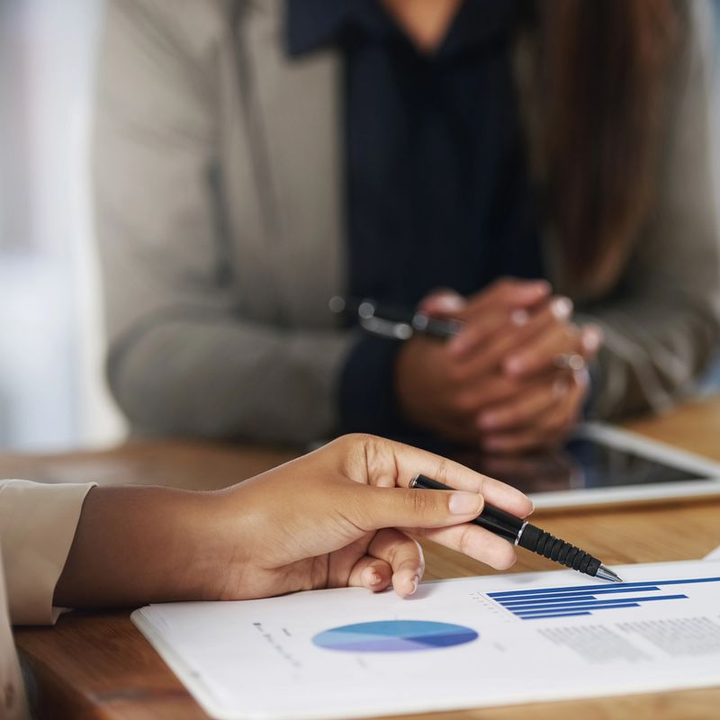 Cropped shot of two unrecognisable businesspeople going through paperwork in an office